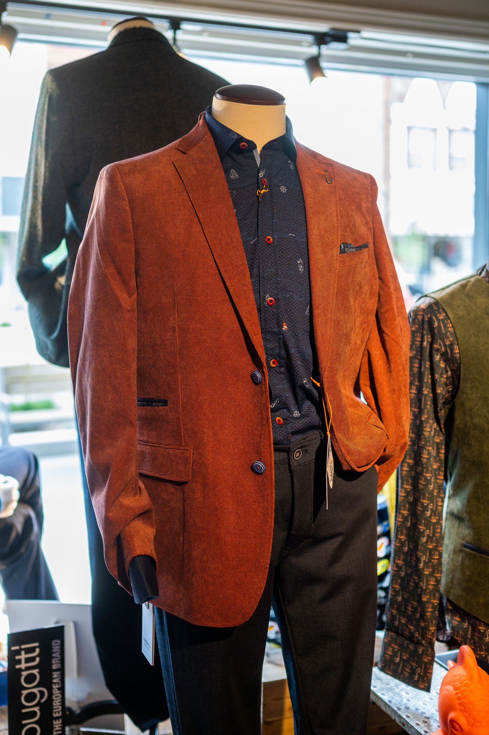 2021 10_TaylorCo-Fall-002 A mannequin with a brown blazer and a colourful dress shirt.